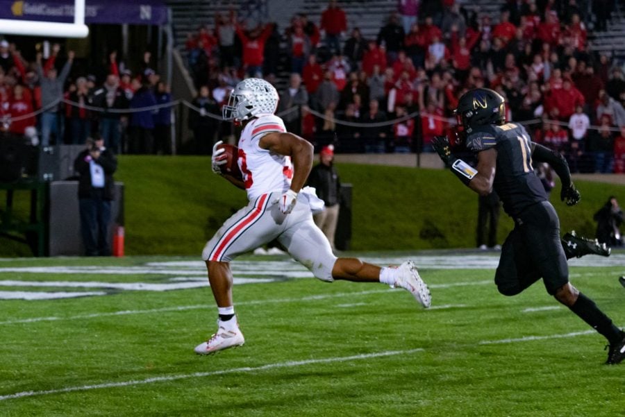 Northwestern cornerback A.J. Hampton chases after Ohio States Master Teague III en route to a 73-yard touchdown. The Buckeyes demolished the Wildcats 52-3 Friday at Ryan Field.