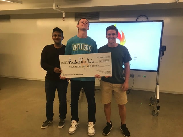 From left, Karim Noorani, Nathan Graber-Lipperman and Owen Guetschow pose with their $4,000 check in The Garage.