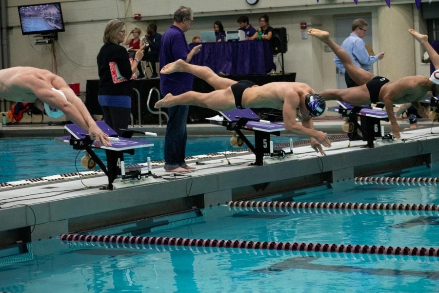 A Northwestern swimmer leaps into the pool. The Wildcats beat Michigan State on Saturday for their first Big Ten dual meet win in nearly six years.