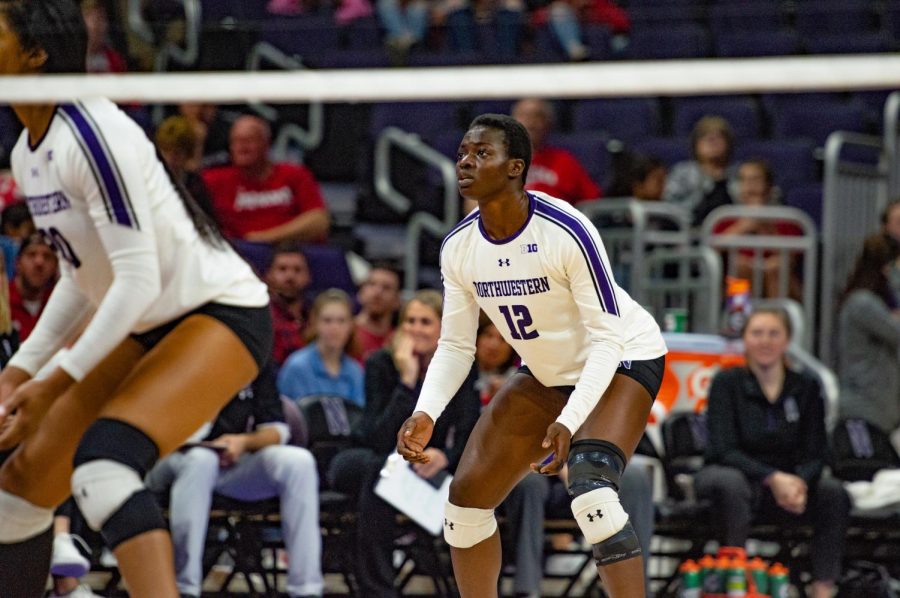 Temi+Thomas-Ailara+prepares+to+receive+a+serve.+The+freshman+outside+hitter+returned+after+missing+the+last+couple+of+games.+