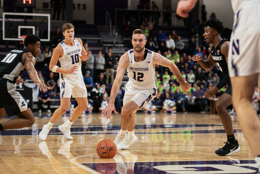 Pat Spencer drives the lane. The graduate guard ran NU’s late game offense in the win against Providence.