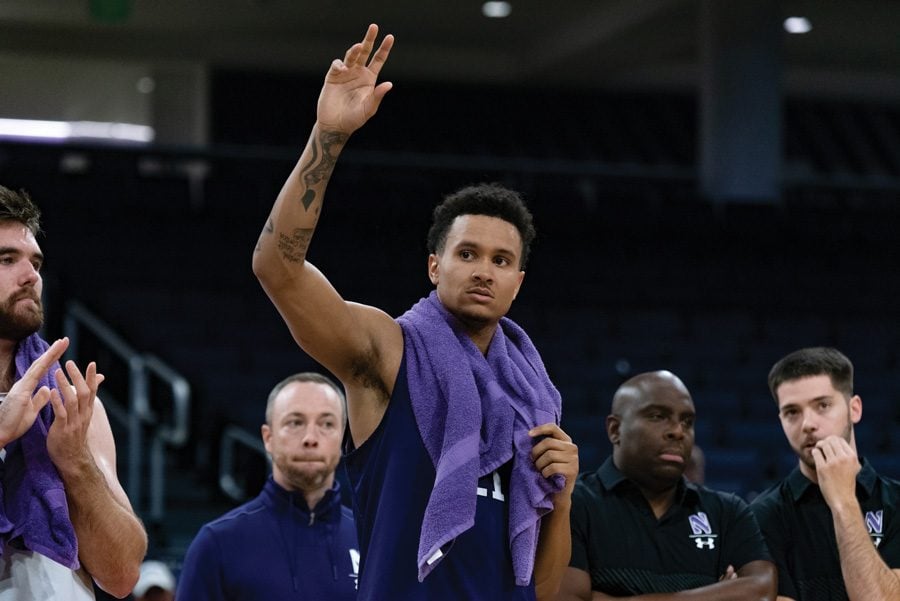 A.J. Turner waves to the fans. The senior forward and NU will play in the season opener Friday.