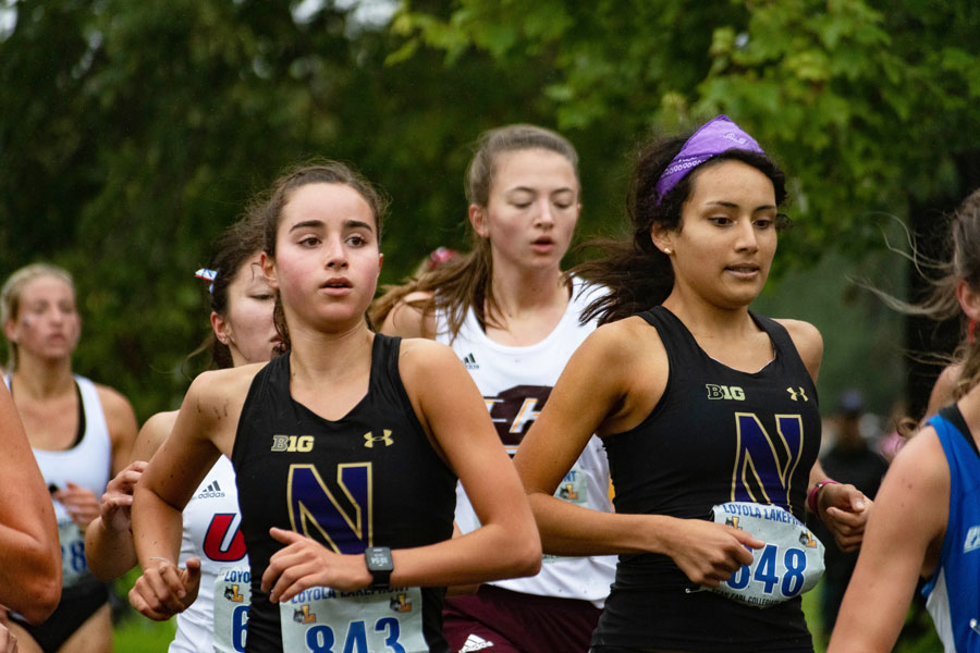 Kayla Byrne runs in a crowded pack of athletes. The freshman finished her 6k Friday with a time of 22:53.7.