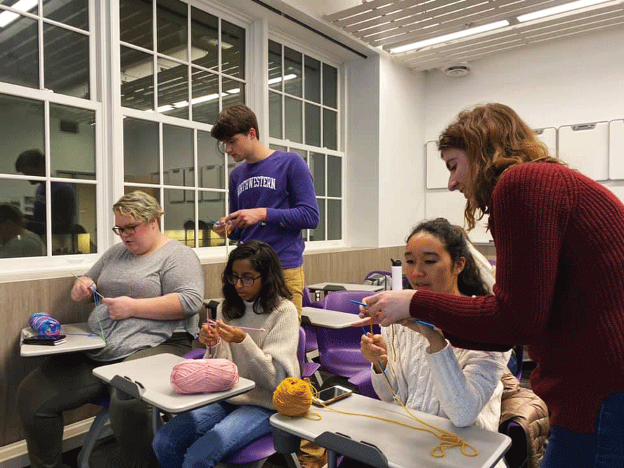 Weinberg sophomore Sarah Eisenman (far right) teaches members to knit at an Oct. 28 club meeting.