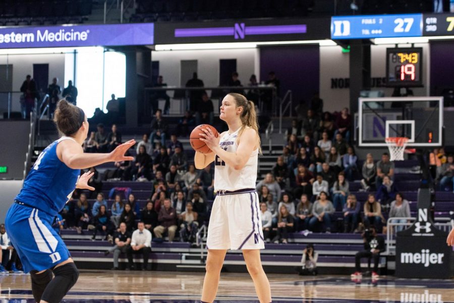 Abbie Wolf holds the ball. The senior center scored a team-high 18 points in NU’s loss to DePaul on Sunday.