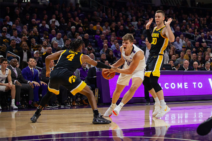 Miller Kopp makes a move through two defenders. The Wildcats dropped their fifth Big Ten contest of the season to Iowa on Thursday night.