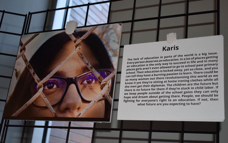 A photograph and artist statement by Chute Middle School eighth-grader Karis Martin hang in the photovoice art exhibit at Evanston Public Library. Martin’s piece focused on global education disparities for girls.