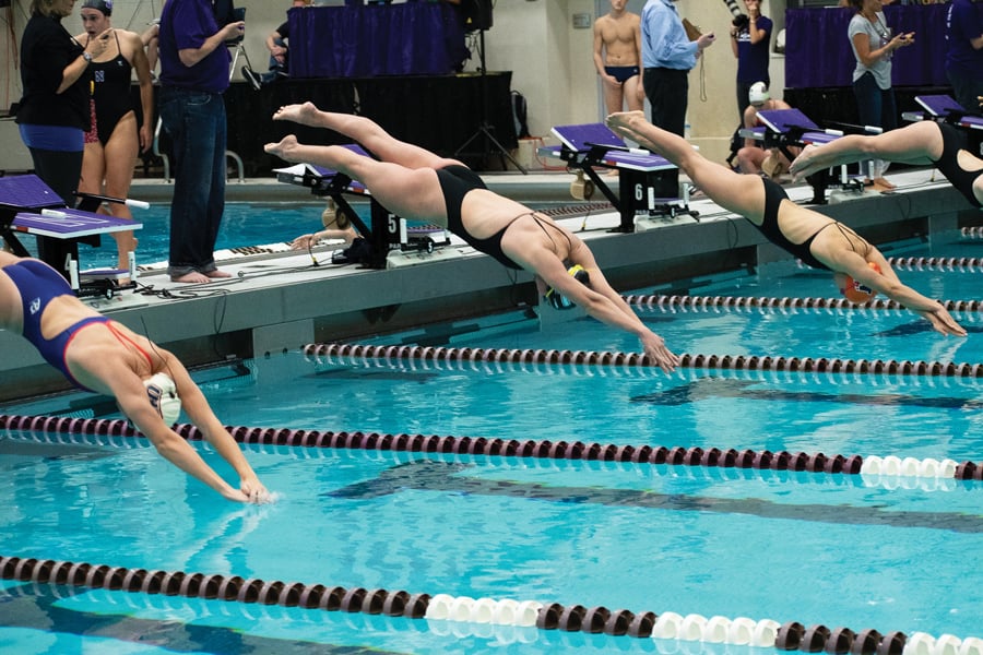 Calypso Sheridan dives in the pool. The junior swimmer was one of four who broke NU’s 200-yard medley relay.