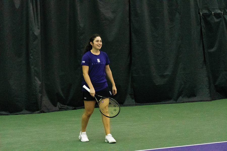 Inci Ogut smiles during a match. The junior beat her singles opponent in two sets on Saturday.
