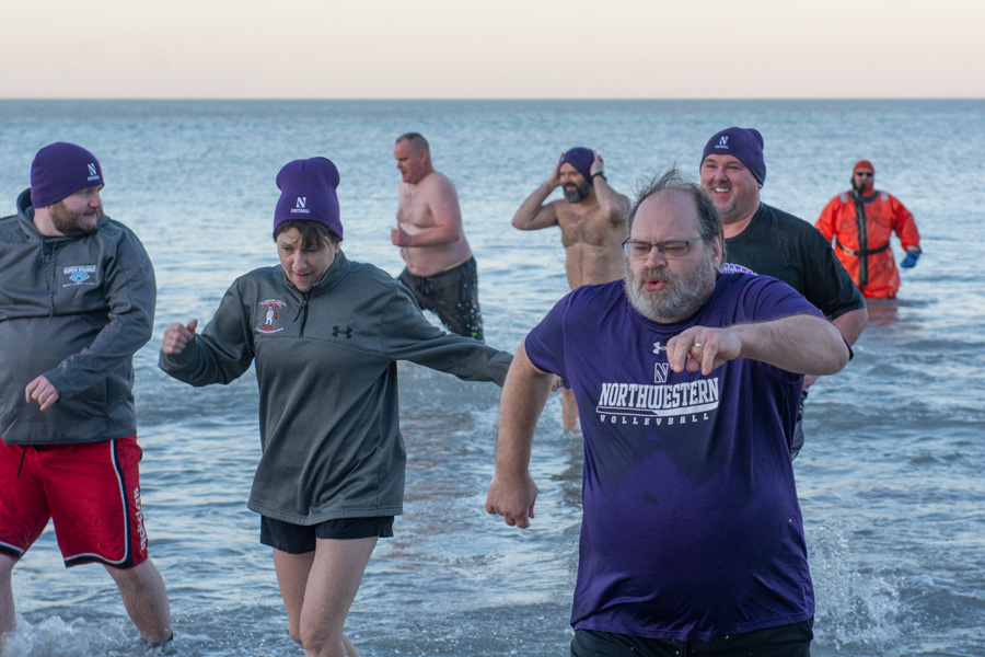 Participants in the Illinois Special Olympics Super Plunge run out of Lake Michigan after completing their fourth of 24 jumps into the lake. Approximately 55 people raised money and awareness this weekend for the organization through the event.