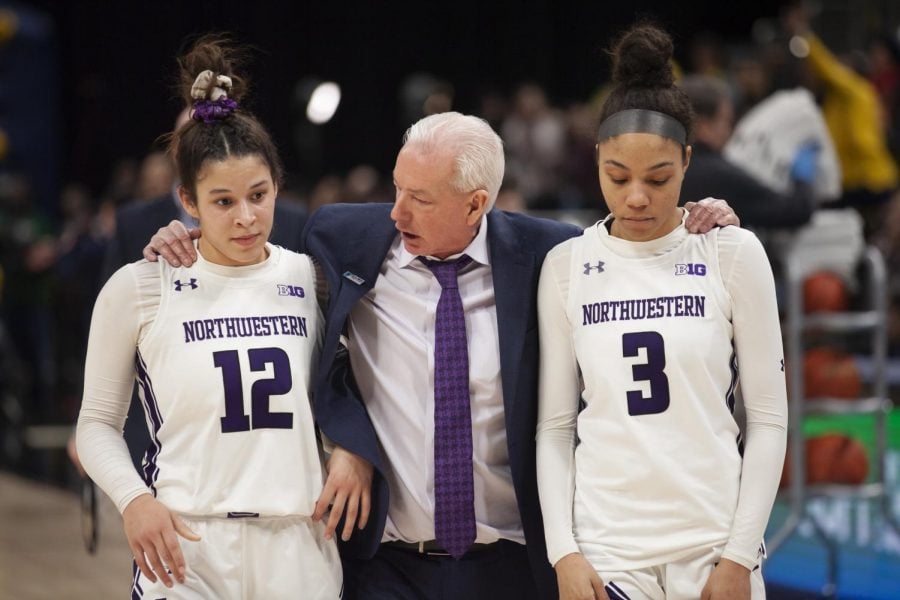 Joe McKeown consoles Veronica Burton and Sydney Wood. The Wildcats lost their opening round game of the Big Ten Tournament to Michigan. 