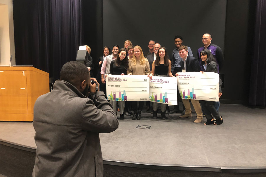 The winners, organizers and judges of this year’s ImproveNU pose for photos after the event. The event awarded $11,000 in grants to three student groups to implement their proposed ideas to improve campus.