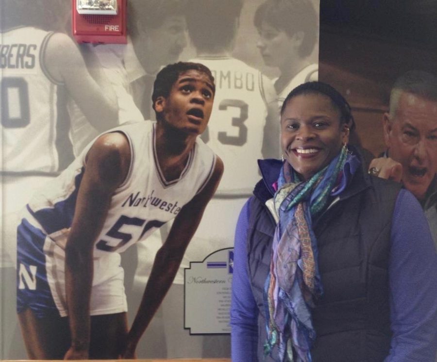 Anucha Browne stands in front of an image of herself. Browne will go down as one of the best basketball players in Northwestern history.