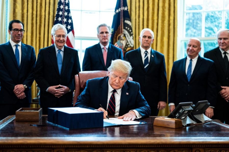 U.S. President Donald Trump signs H.R. 748, the CARES Act in the Oval Office of the White House on March 27, 2020 in Washington, D.C. Earlier that day, the U.S. House of Representatives approved the $2 trillion stimulus bill that lawmakers hope will battle the economic effects of the COVID-19 pandemic.