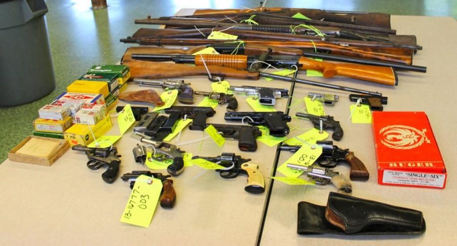 Police officers displayed the firearms they collected at Evanstons second gun buyback event in 2013. EPD collected 28 guns at Saint Nicholas Church.