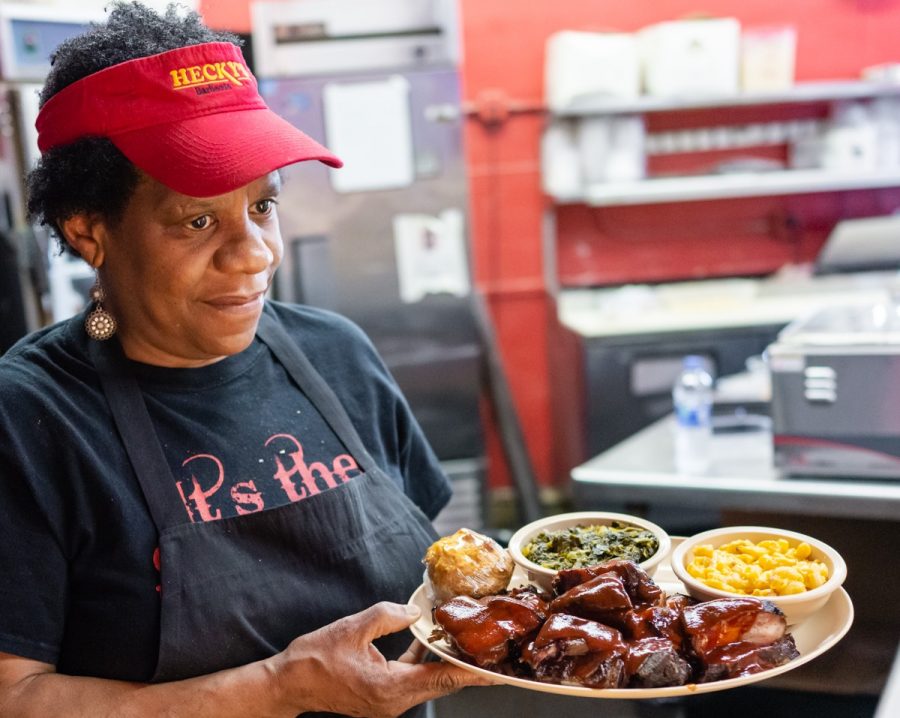 Employees at Hecky’s Barbecue continue to serve barbecue to customers. While social distancing and extra cleaning measures have been implemented, not much else has changed.