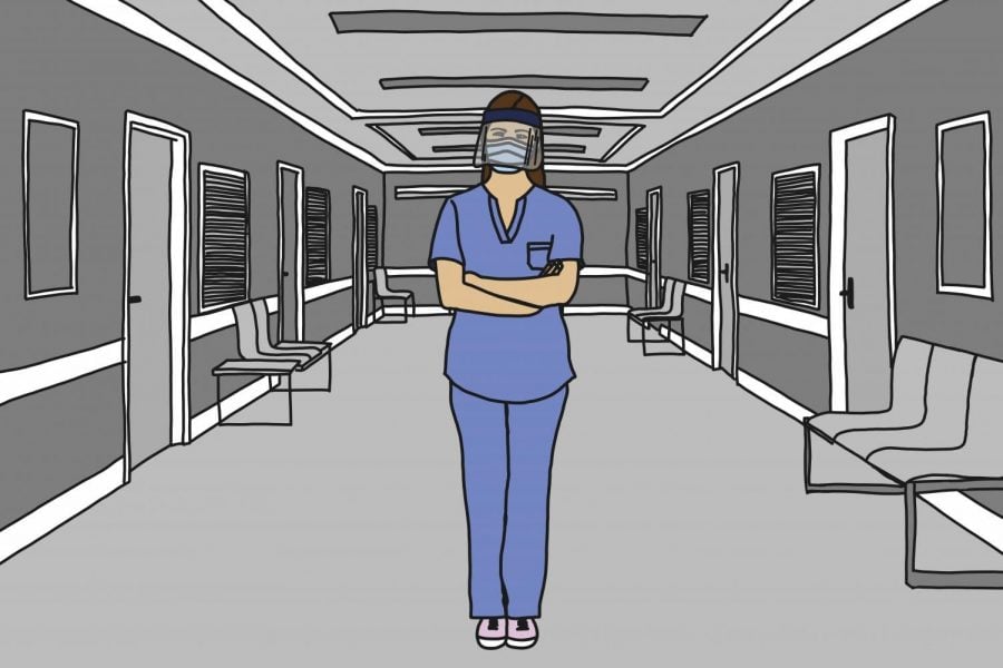 A masked health care worker in a hospital hallway. For those who are Deaf, masks can create barriers to communication in emergency care.