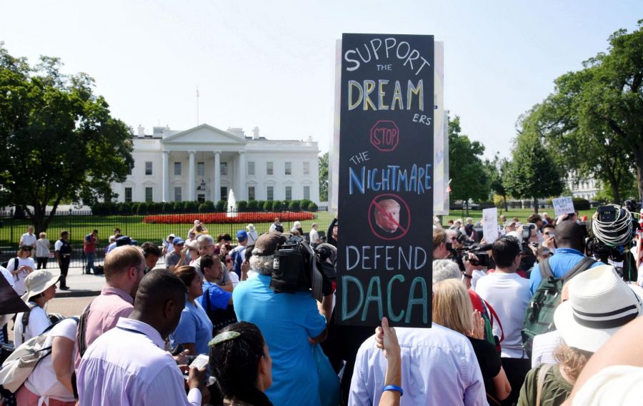Protesters hold up signs during a rally supporting Deferred Action for Childhood Arrivals, or DACA, outside the White House on Sept. 5, 2017. The Supreme Court blocked the Trump administration’s rescission of the program Thursday.
