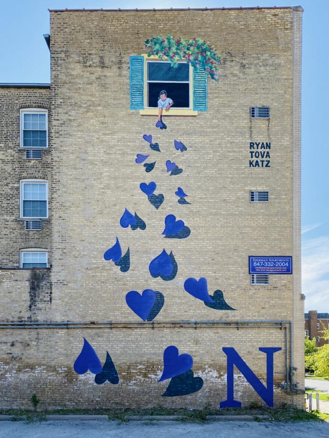 Fifteen purple hearts and a little girl decorate a wall at 829 Foster St. 