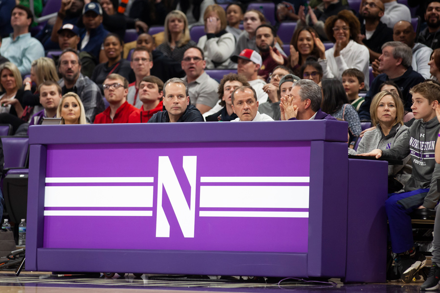 Chris Collins and Jim Phillips sit courtside at a game. The NCAA and its athletic programs face an uncertain future for collegiate sports. 
