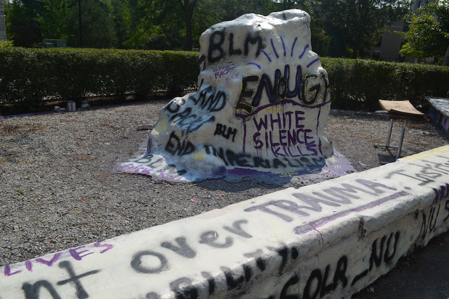 The Rock. After “White Silence Kills” was painted over with “NU,” students painted it to say “enough.”