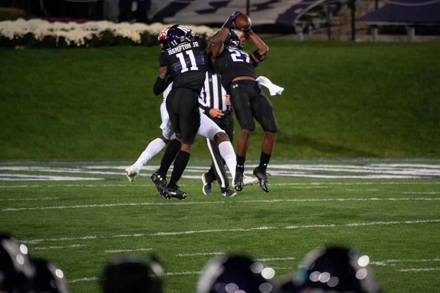 Coco+Azema+snags+his+first+interception+of+the+season.+The+freshman+safety+was+one+of+three+Wildcats+with+an+interception.+