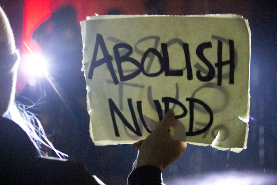 A+protester+holds+a+sign+at+a+Wednesday+night+event.+The+event+ended+at+Mayor+Steve+Hagerty%E2%80%99s+house.+%0A