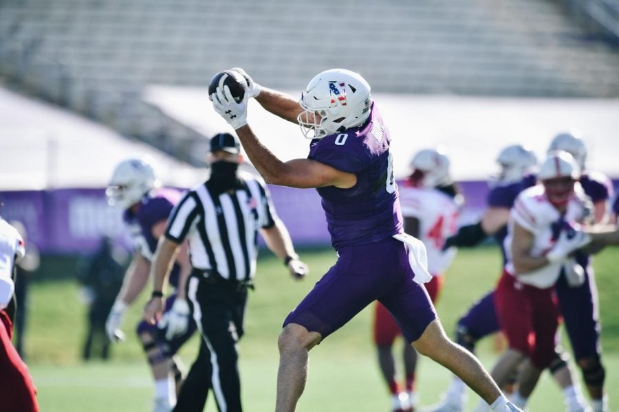 John Raine catches a pass against Nebraska. The graduate transfer has emerged as one of Northwestern’s top offensive players this 2020 season.