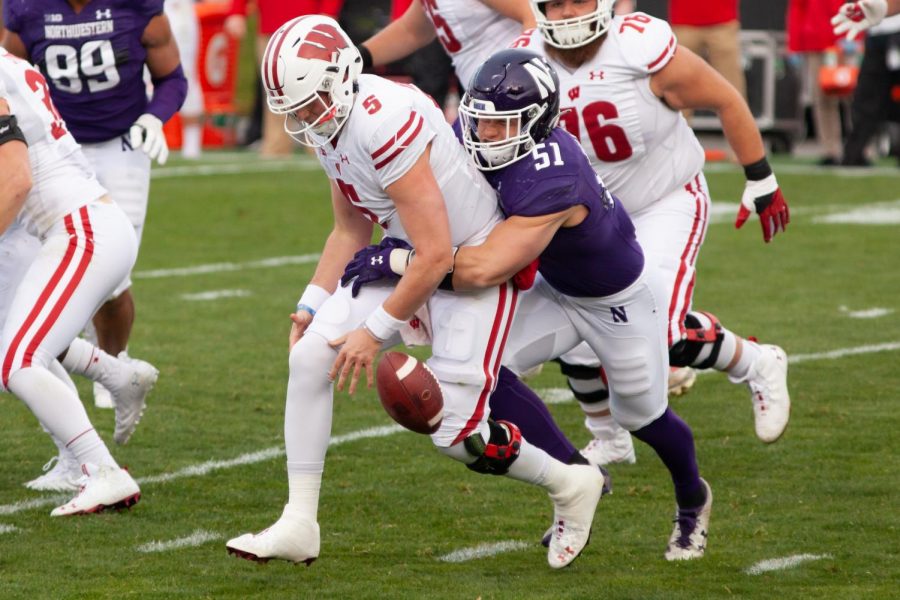 (Joshua Hoffman/The Daily Northwestern) Blake Gallagher tackles Wisconsin quarterback Graham Mertz.