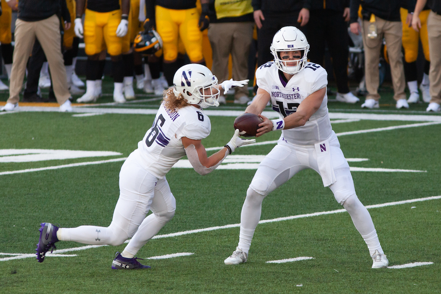 Peyton Ramsey holds the ball out for Drake Anderson on an RPO. The graduate quarterback will lead the Cats in the next step of their chase for a Big Ten West title against Nebraska.