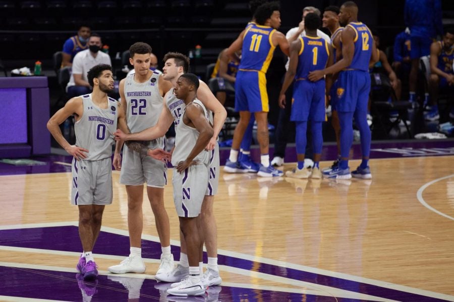 The Wildcats huddle during their ACC/Big Ten Challenge matchup against Pitt. Northwestern lost by a point after a disastrous final minute.