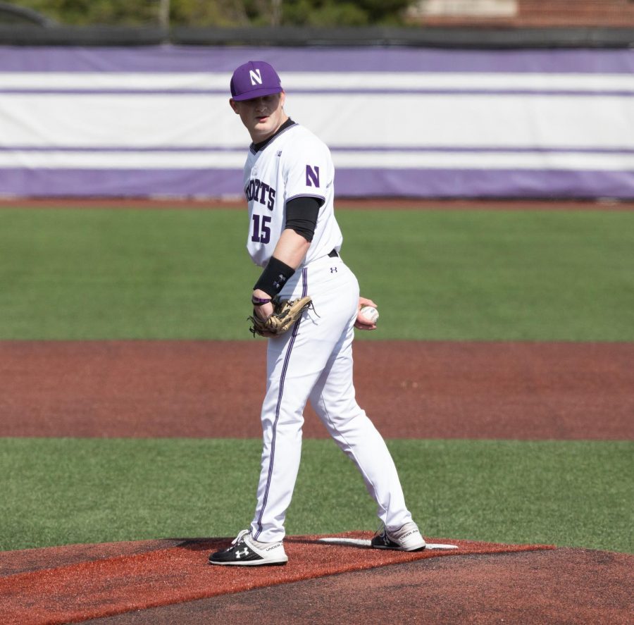 Northwestern+player+looks+to+first+base+between+pitches.