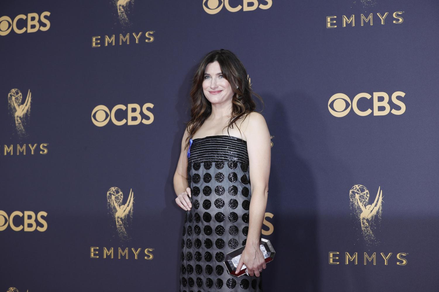 Actress+and+alumna+Kathryn+Hahn+stands+in+a+black+polka-dot+dress+in+front+of+a+navy+background+with+words+%E2%80%9CEmmys%E2%80%9D+and+%E2%80%9CCBS%E2%80%9D+in+gold.