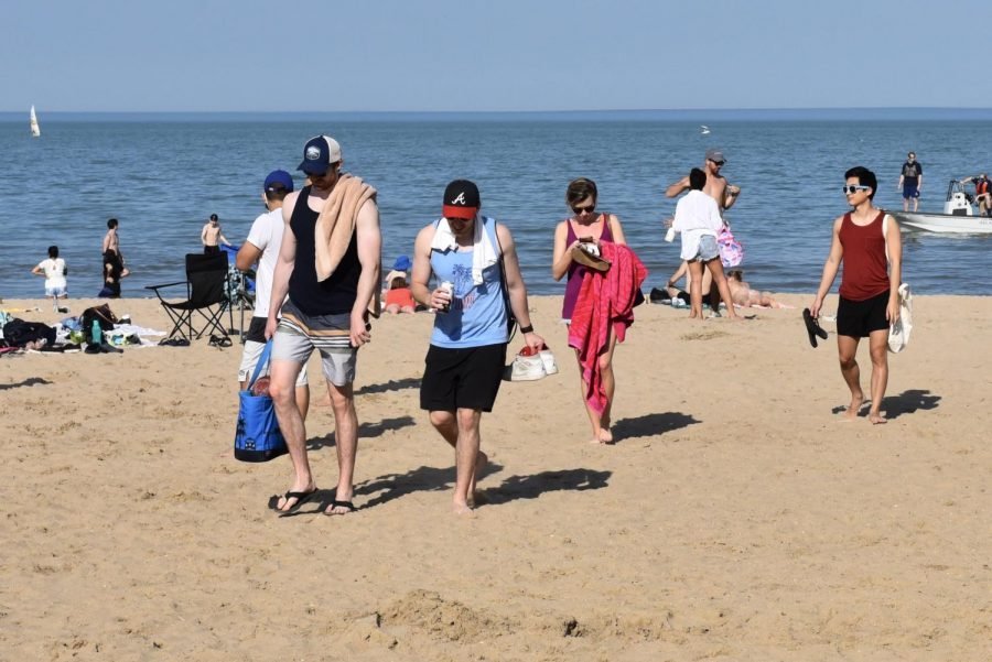 Students and Evanston residents walk on the beach near the Segal Visitors Center.