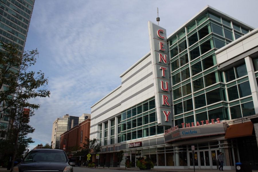 Century 12 movie theater pictured outside during mid-day, at its Church Street location surrounded by other businesses, sidewalks and passerby.