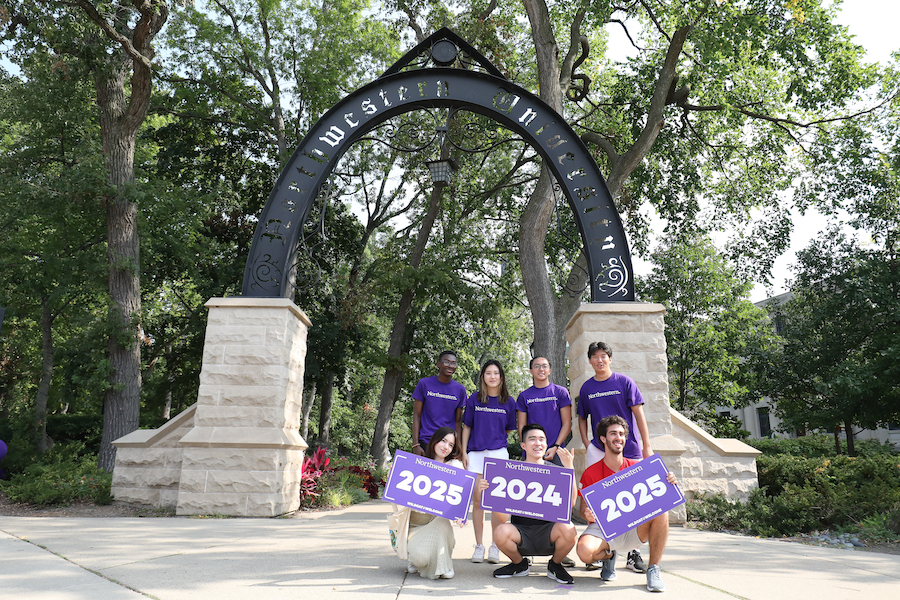 Members of the classes of 2024 and 2025 pose in front of The Arch during move-in.
Alt text: Seven new students pose for a photo with signs under Weber Arch.