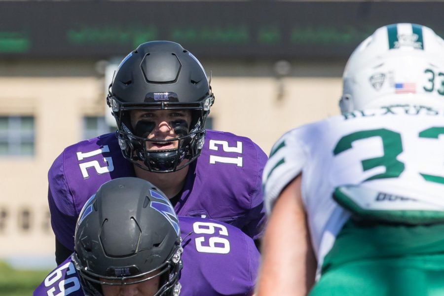 Football player eyes down the defense.