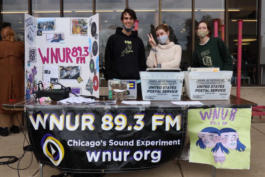 Members of WNUR, the student-run radio station, pose at their table.