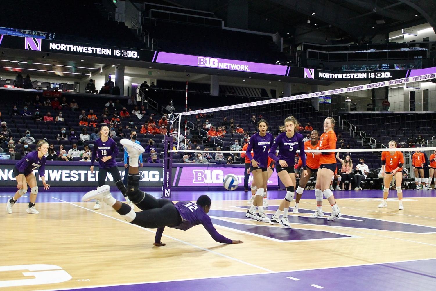 Player+in+purple+jersey+dives+to+floor+to+hit+ball.