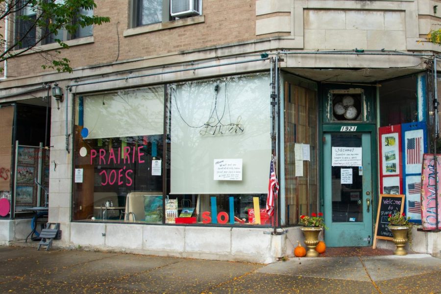 The exterior of Prairie Joe’s. Paintings are propped up in the windows.