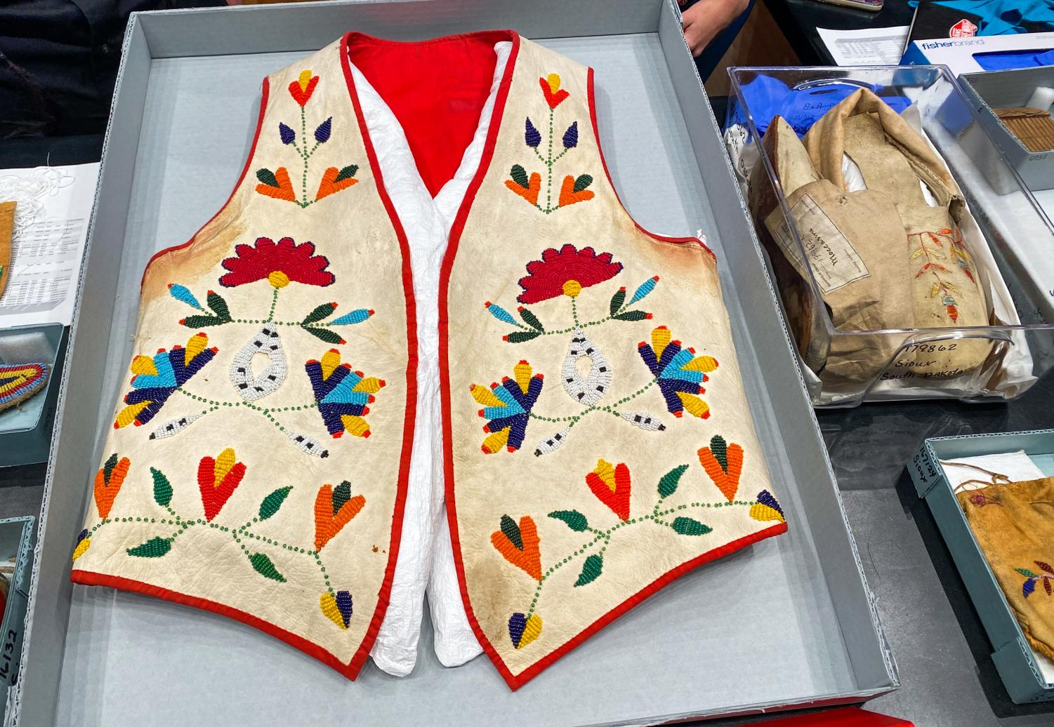 A+colorful%2C+beaded+white+vest+with+floral+patterns+and+red+lining