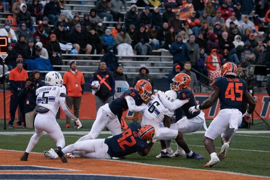 Malik Washington is tackled by Illinois defenders. The Northwestern junior wide receiver reeled in seven catches for 83 yards in the Wildcats' 47-14 loss to Illinois.