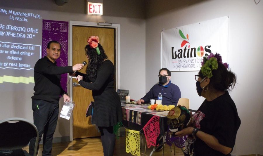 Latinos en Evanston North Shore President Mercedes Fernández and LENS members hand out prizes at their Day of the Dead celebration.