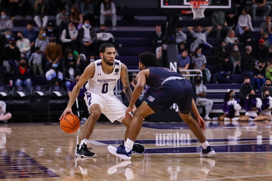Boo Buie dribbles the basketball. The Cats rolled to their fourth victory of the season.