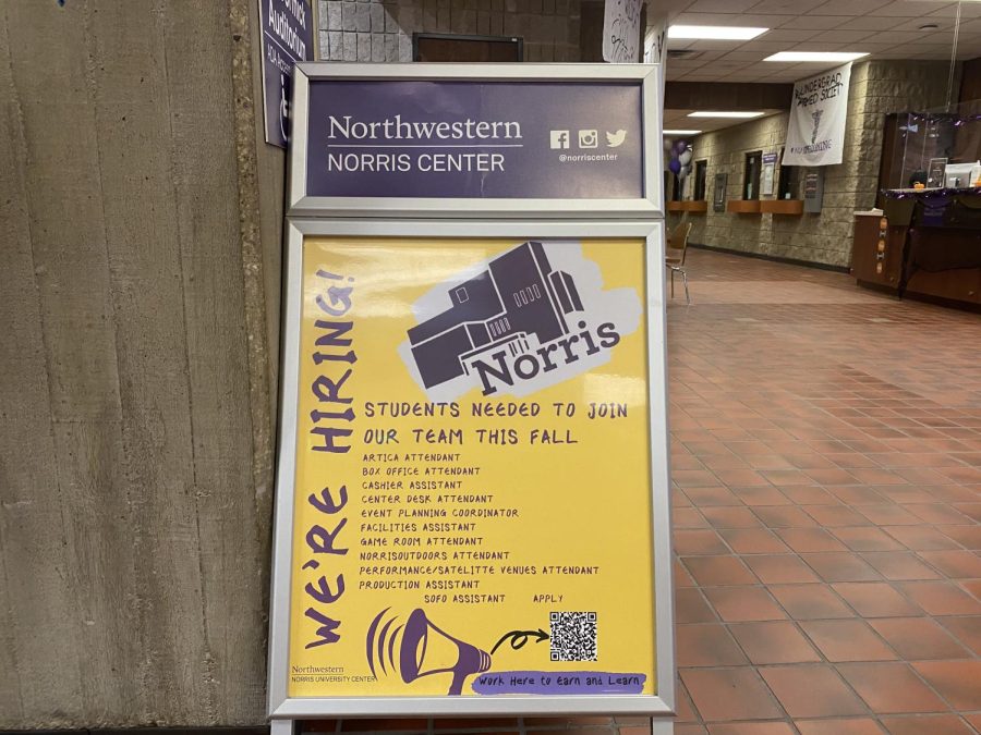 Hiring sign propped up in Norris University Center reading “We’re Hiring! Students Needed to join our team this fall” along with a QR code for the application.
