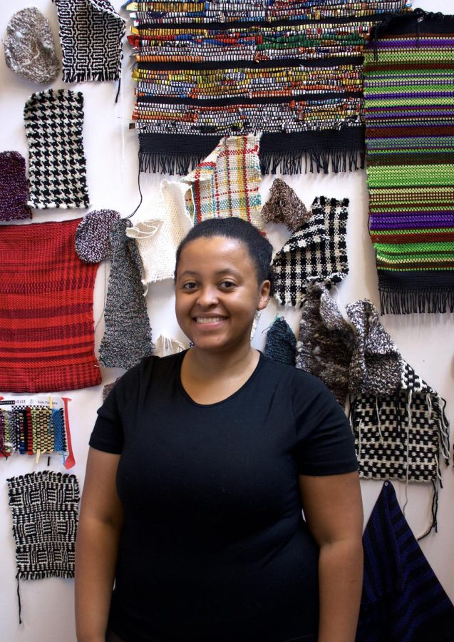 Local+textile+artist+Bryana+Bibbs+stands+in+front+of+several+of+her+weavings.