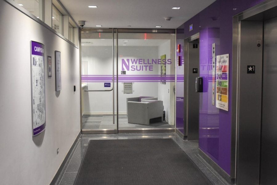 The entrance to the Wellness Center at Henry Crown Sports Pavilion, featuring glass doors with purple lettering.