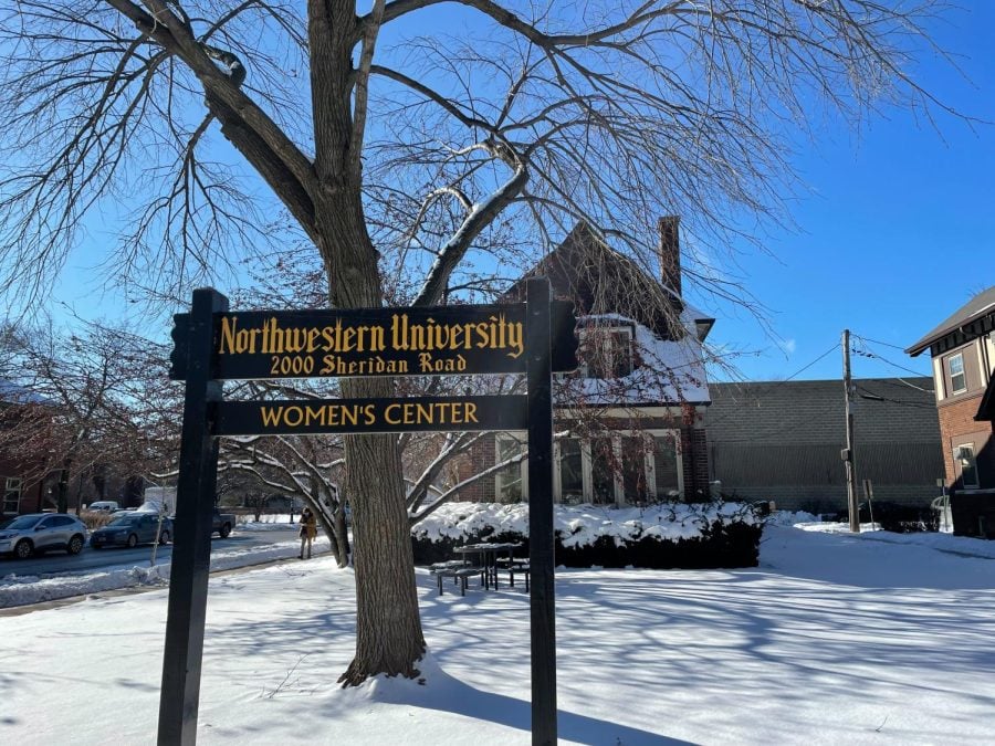 Sign reading “Northwestern University Women’s Center” in front of the center’s snow-covered yard and building.