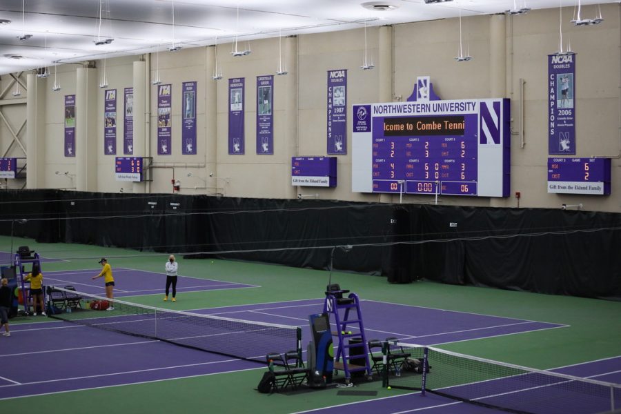 A+purple+scoreboard+sits+above+a+purple+and+green+court%2C+with+purple+banners+hanging+from+the+walls.