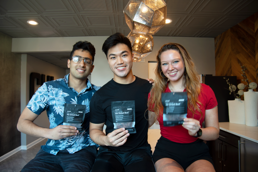 The Minimal Snacks leadership team. Ansh Prasad (left), Ryan Teo (center) and Liliana Sydorenko (right), pose with their debut product, MNML Air Dried Beef.